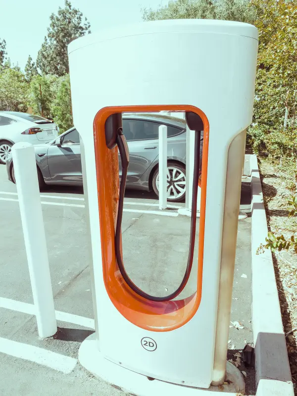 Electric vehicle charging station in an outdoor parking area