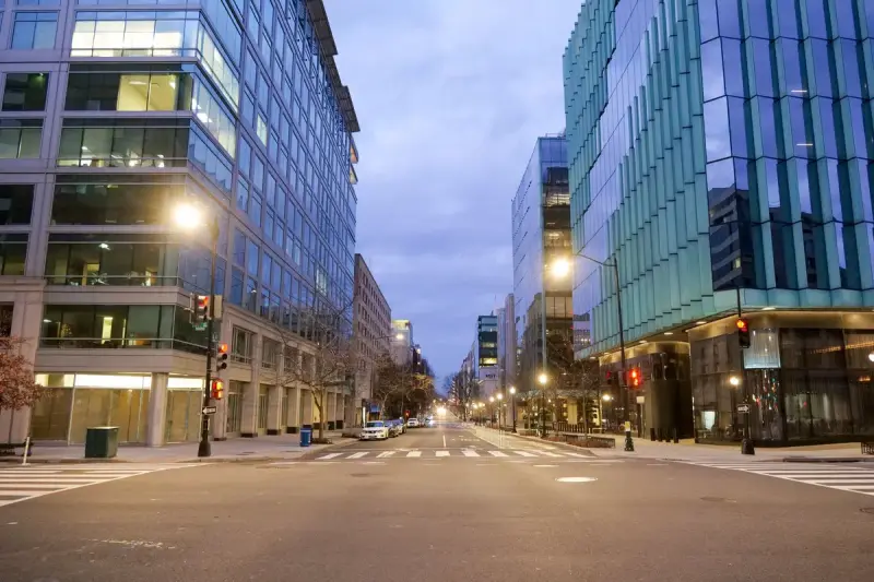 Empty downtown Washington, D.C. street lined with modern office buildings at dawn