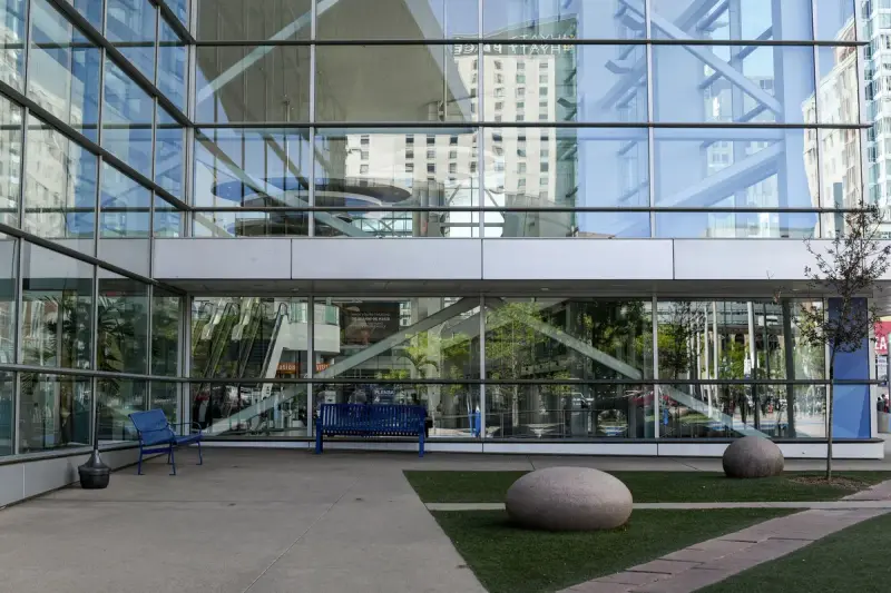 Glass facade and entrance plaza of the Colorado Convention Center in downtown Denver