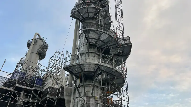 Refinery column surrounded by scaffolding during maintenance
