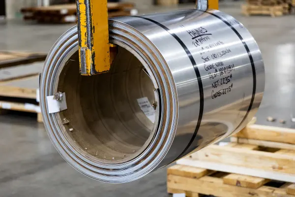 Close view of a large metal coil inside an industrial facility