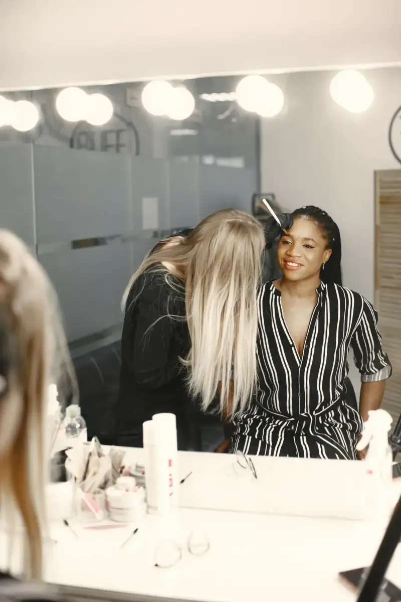 Hairdresser styling a woman’s hair in a salon