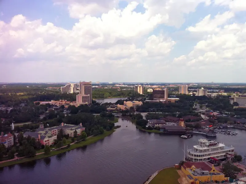 Aerial view over Lake Buena Vista's lakeside resort hotels toward Orlando under summer clouds