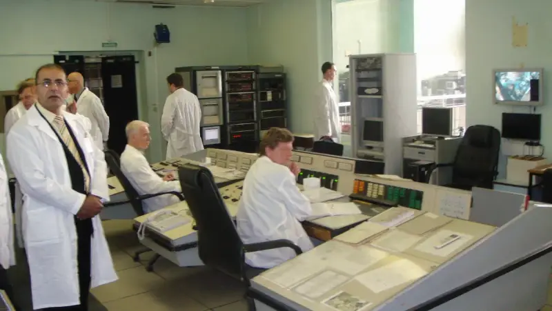 University research reactor control room with consoles and monitoring screens