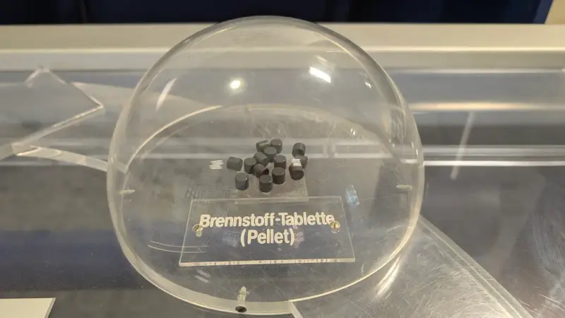 Display of small cylindrical nuclear fuel pellets in an exhibit case