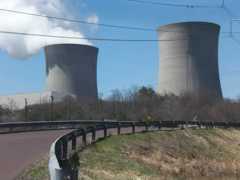 Twin hyperbolic cooling towers of a Pennsylvania nuclear station seen across fields