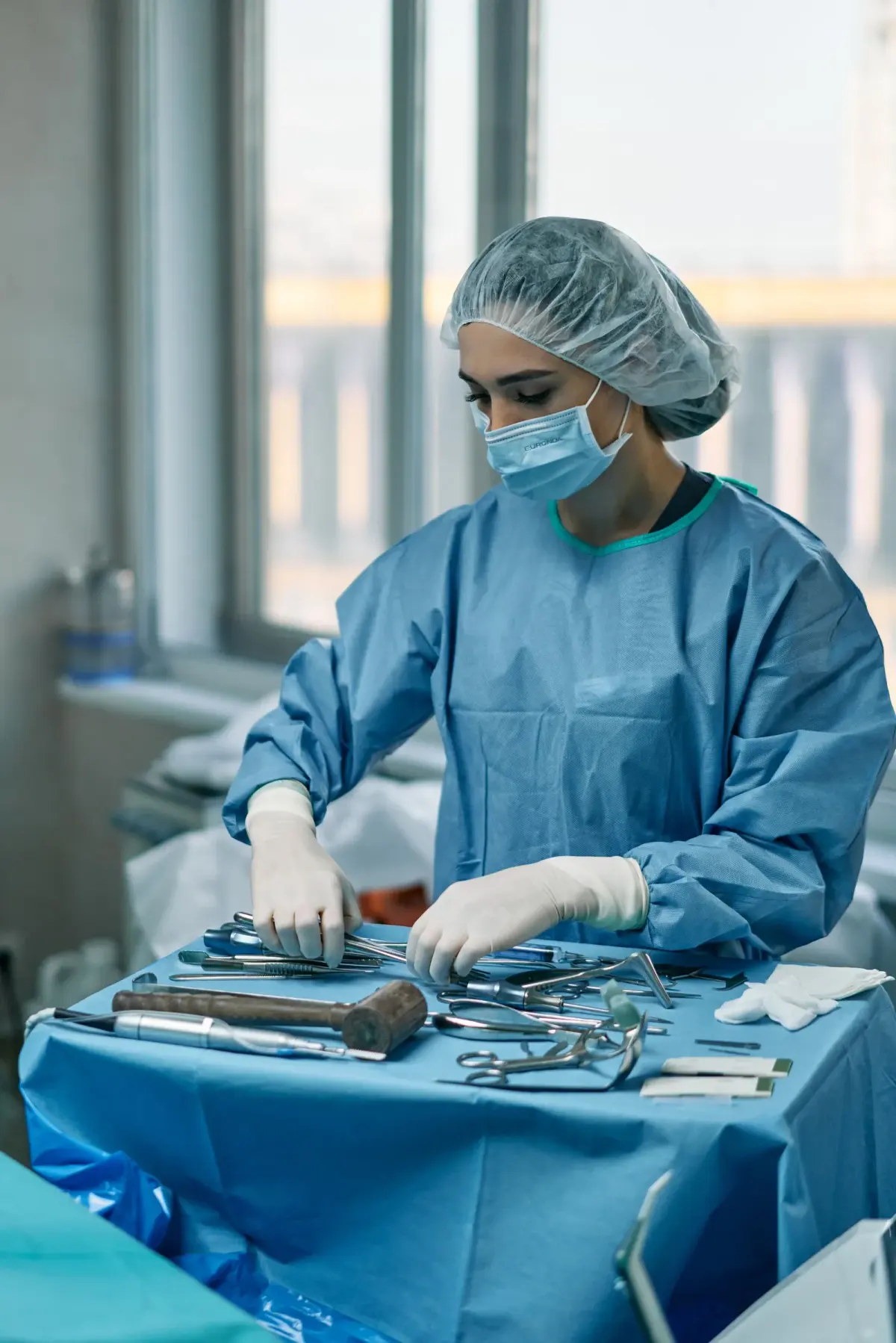 Woman arranging medical instruments in an operating room