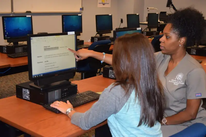 Occupational therapist helping a client prepare a résumé