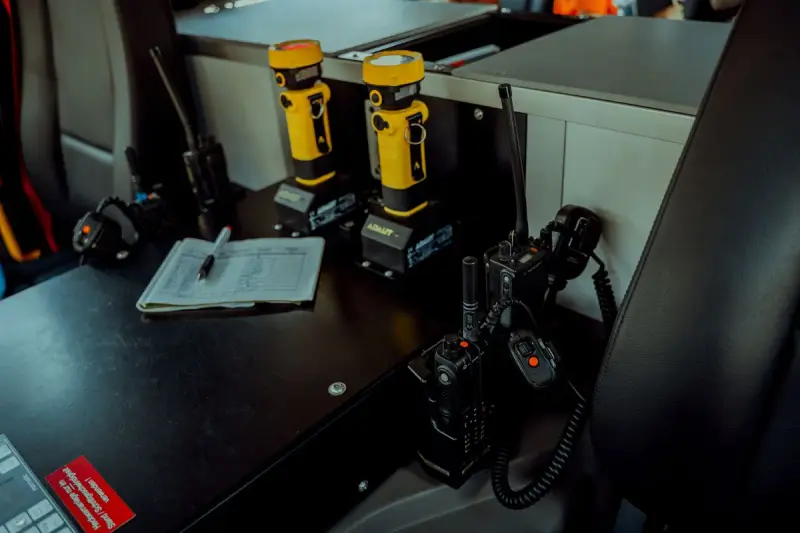 Radio and communication equipment on a work table inside a command vehicle