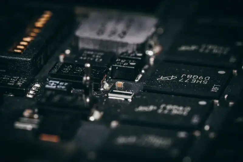 Macro view of black integrated circuits and components on a densely packed board