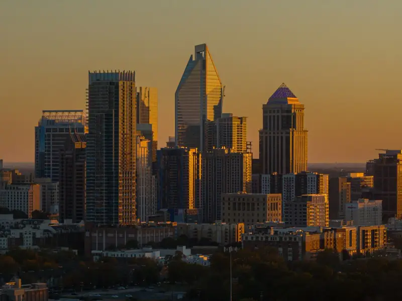 Charlotte towers glowing in golden light at dusk