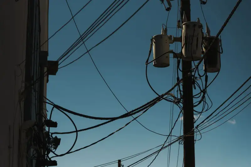 Low angle view of voltage transformers mounted on a utility pole