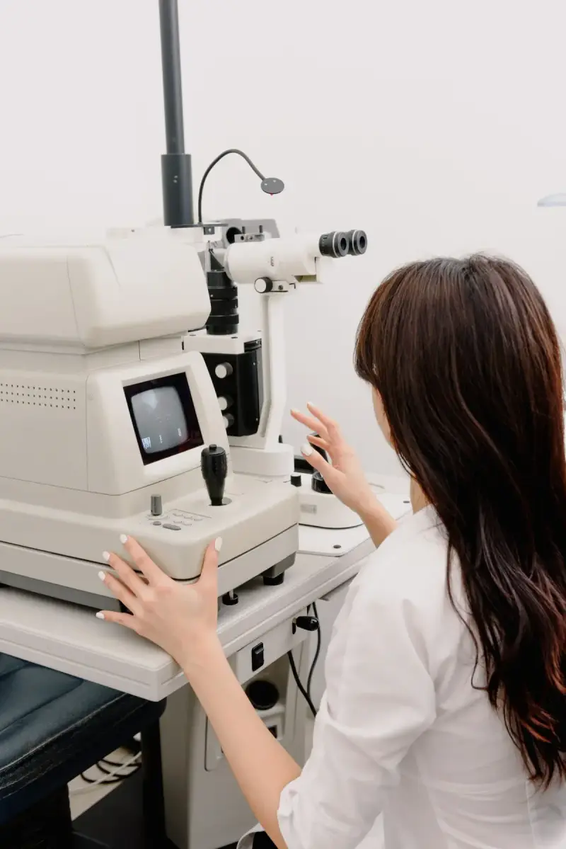 Woman at ophthalmic examination equipment