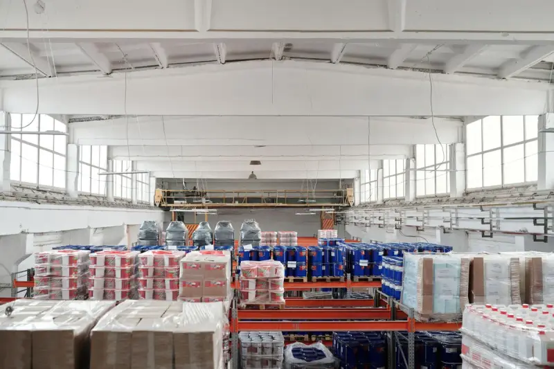 Large distribution warehouse with racks of pallets and shrink-wrapped merchandise