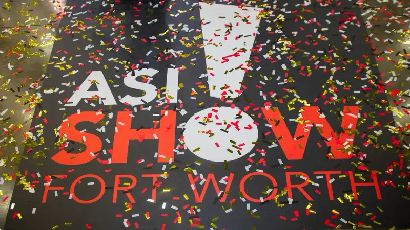 Confetti scattered over a large ASI Show Fort Worth graphic on the floor