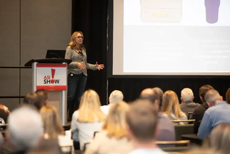Speaker at an ASI Show podium presenting to a full education session