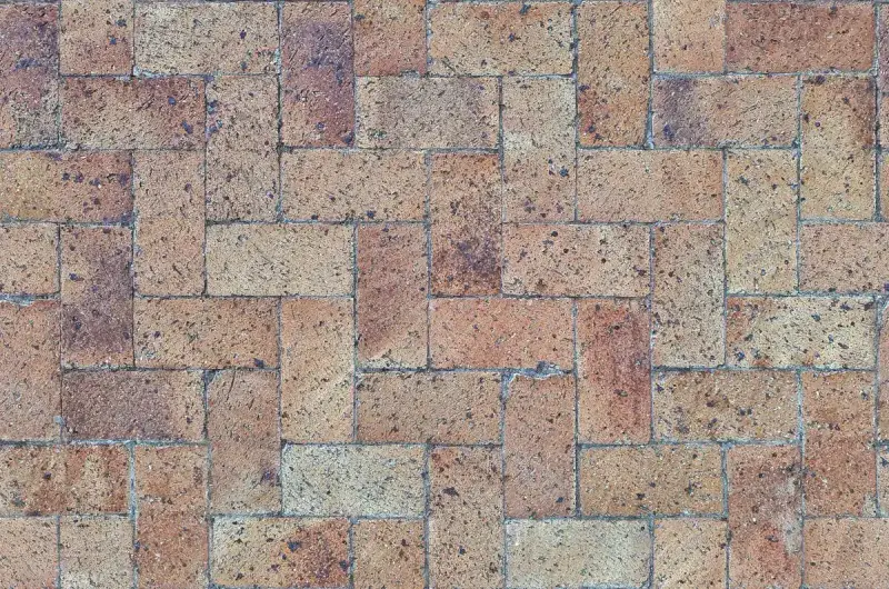 Top view of brick pavers laid in a herringbone pattern