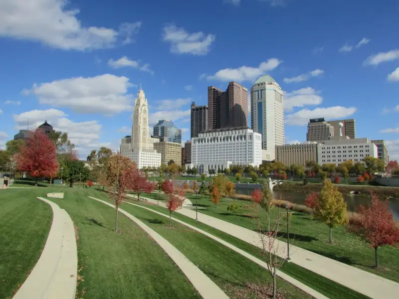Downtown Columbus skyline above trees in autumn colors