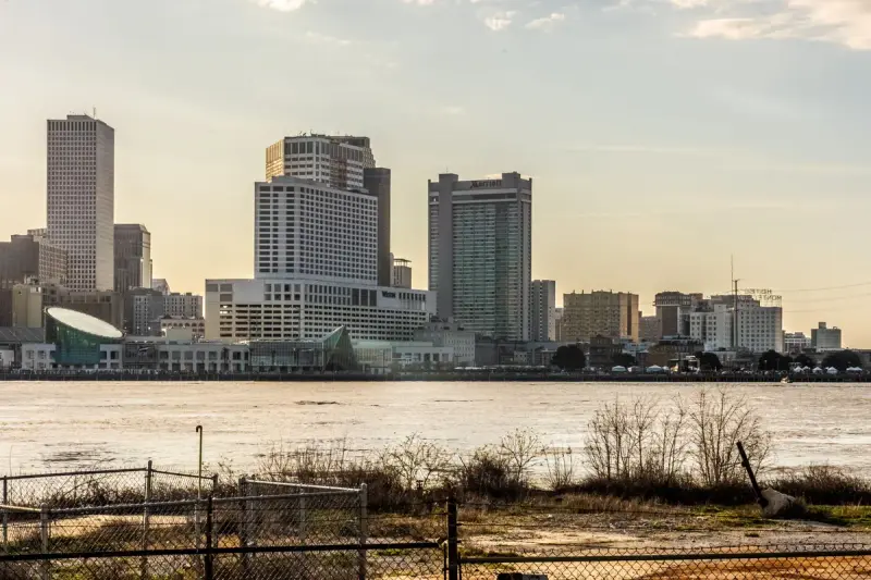 New Orleans skyline seen across the Mississippi River at sunset