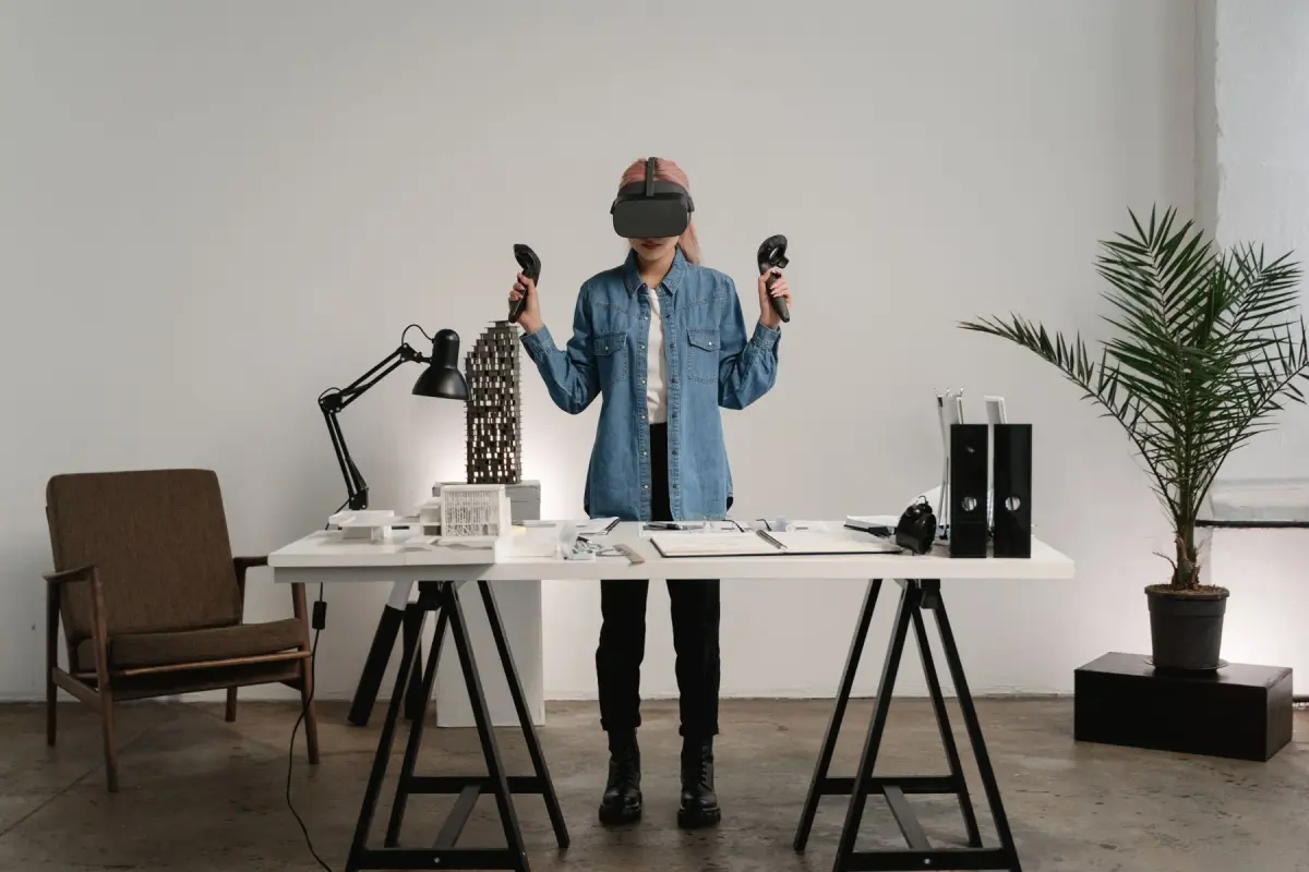 Woman using a virtual-reality headset at a desk in a modern workspace