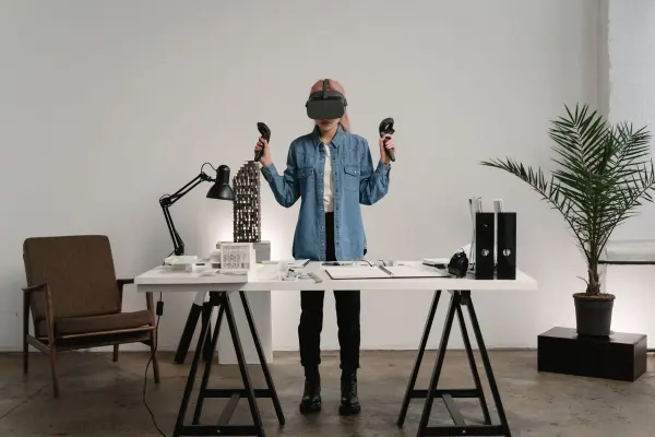 Woman using a virtual-reality headset at a desk in a modern workspace