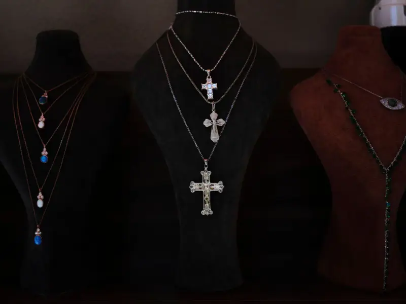 Rows of pendant necklaces on velvet display busts