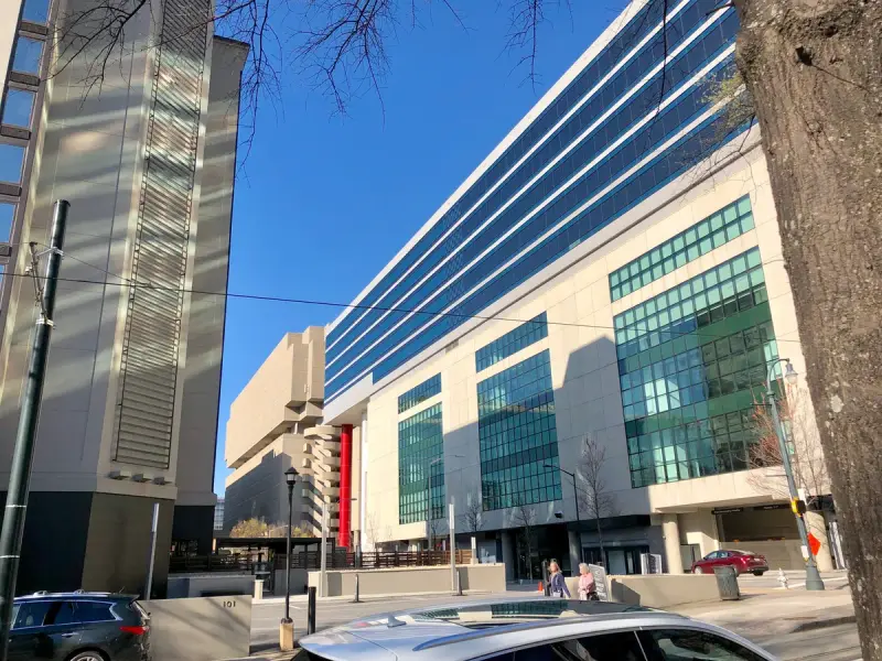 AmericasMart building facade with blue glass upper floors beside older stone towers in downtown Atlanta