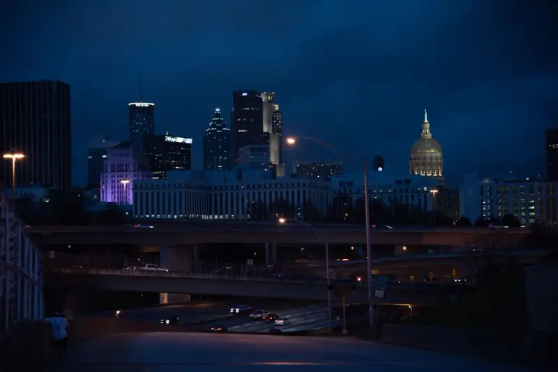 Atlanta skyline at night with lit towers and the gold dome of the State Capitol