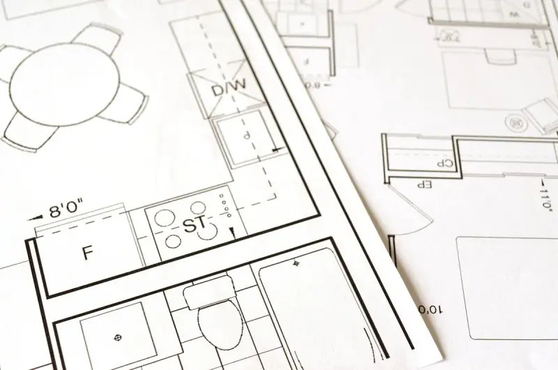 Close-up of printed house floor plans showing a kitchen and bath layout