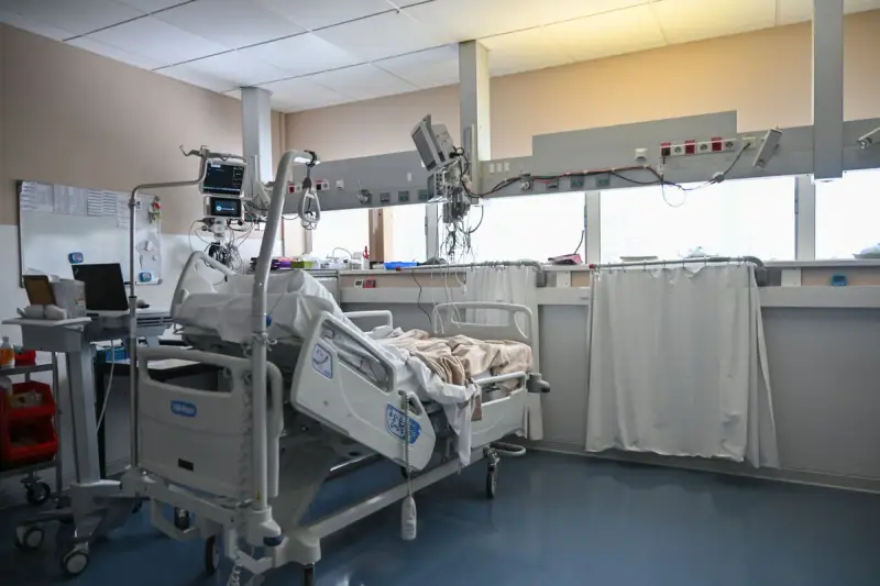 Intensive care unit room with patient bed, monitors and critical care equipment