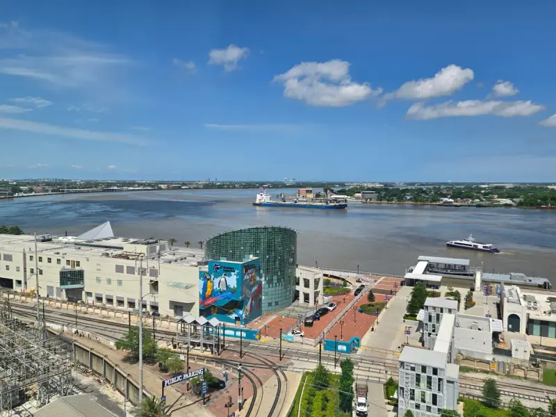 Aerial view of the Mississippi River curving past downtown New Orleans buildings