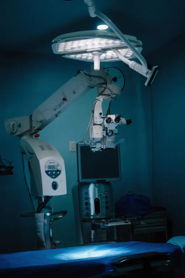 Modern operating room equipment and monitor under blue lighting