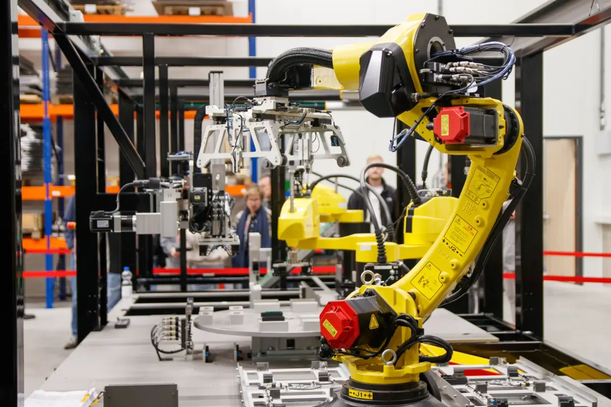 Yellow industrial robot arm inside a manufacturing facility