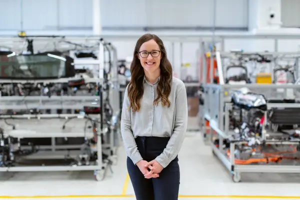 Smiling woman engineer standing in an industrial workshop