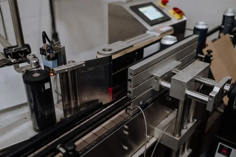 Sensors and a touchscreen controller guiding cans along an automated line