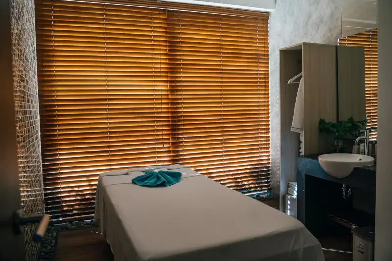 Quiet massage room with a treatment table in soft natural light