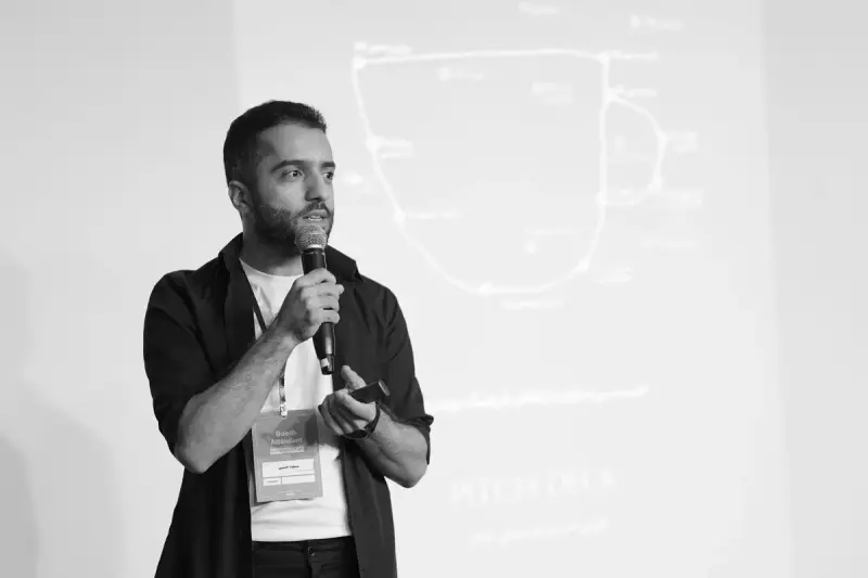 Man speaking into a microphone during a business seminar