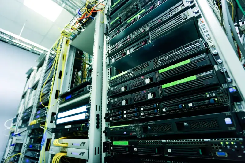 Rows of rack-mounted servers and network cabling in a bright data center