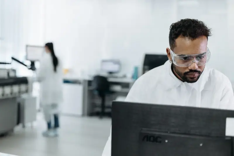 Scientist working at a computer workstation inside a modern lab