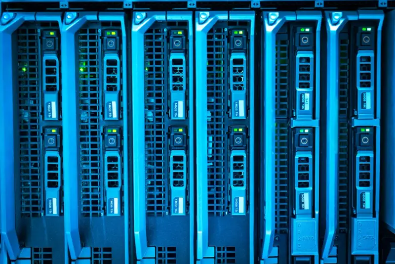 Bank of blade servers glowing blue with status lights