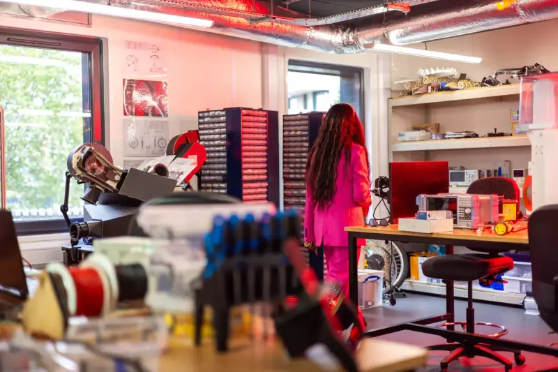 Researcher walking through a colorful, equipment-packed physics and engineering lab