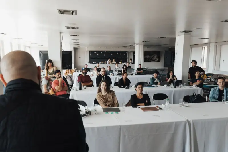 Business professionals following a presentation in a conference room