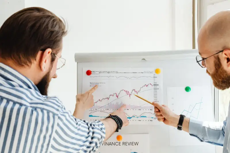 Two professionals analyzing financial charts together