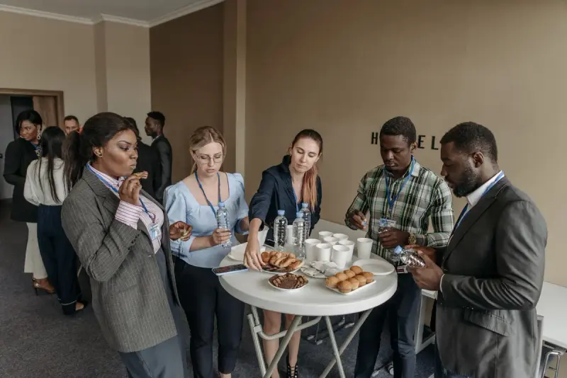 Professionals networking over refreshments at a conference