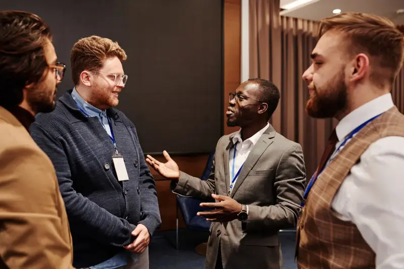 Group of business people in a lively conversation indoors