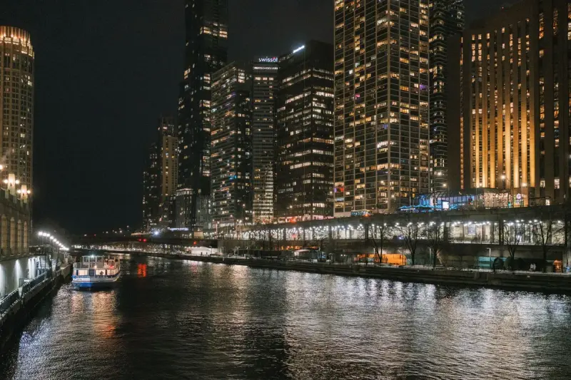 The Chicago River at night with lit skyscrapers reflected in the water