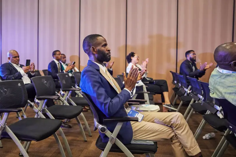Conference audience clapping during a business session
