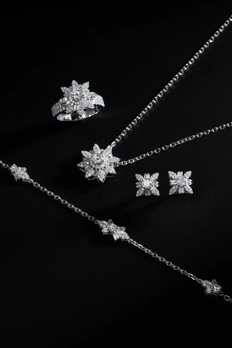 Star-motif diamond necklace, ring and stud earrings arranged on black