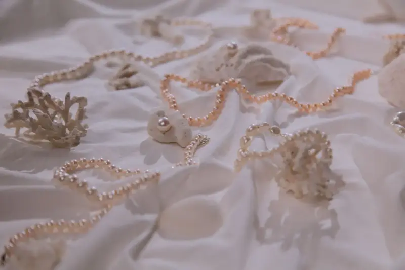 Pearl necklaces draped over coral