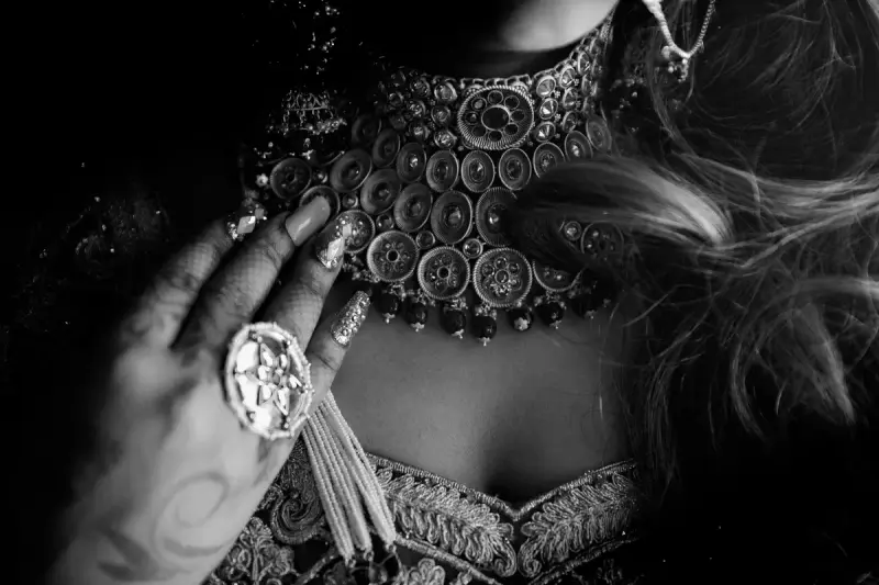 Black and white close-up of a hand wearing ornate jewelry